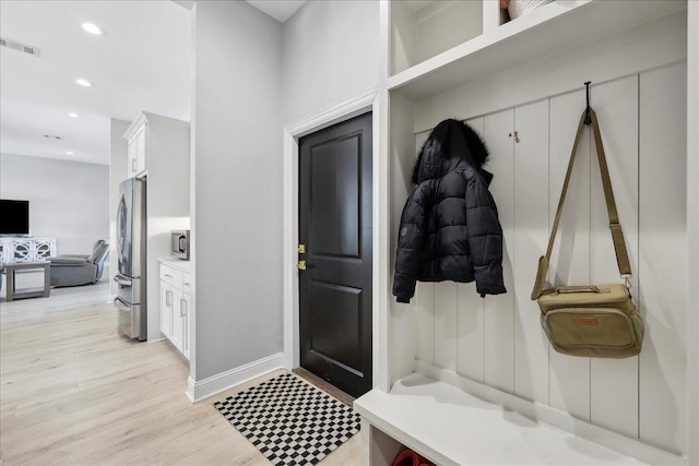 mudroom with recessed lighting, visible vents, and light wood finished floors