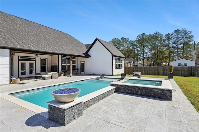 view of swimming pool with a patio, a fenced backyard, an in ground hot tub, french doors, and a fenced in pool