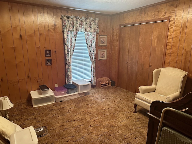 sitting room with carpet flooring and wooden walls