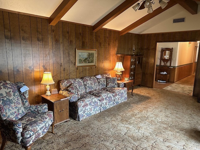 carpeted living room with lofted ceiling with beams, wood walls, and ceiling fan