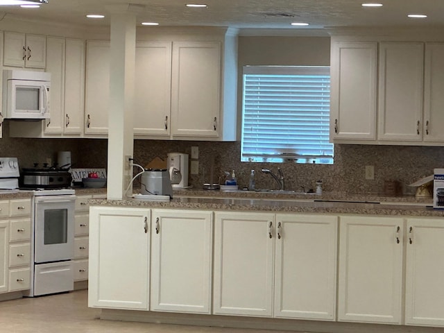 kitchen with white cabinetry, white appliances, and tasteful backsplash