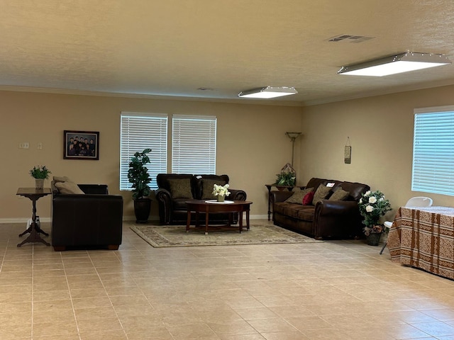 living room featuring crown molding, light tile patterned floors, and a textured ceiling