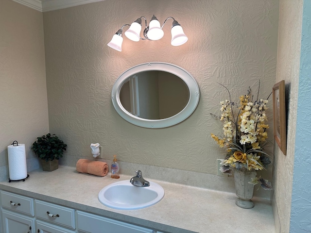 bathroom with vanity and ornamental molding