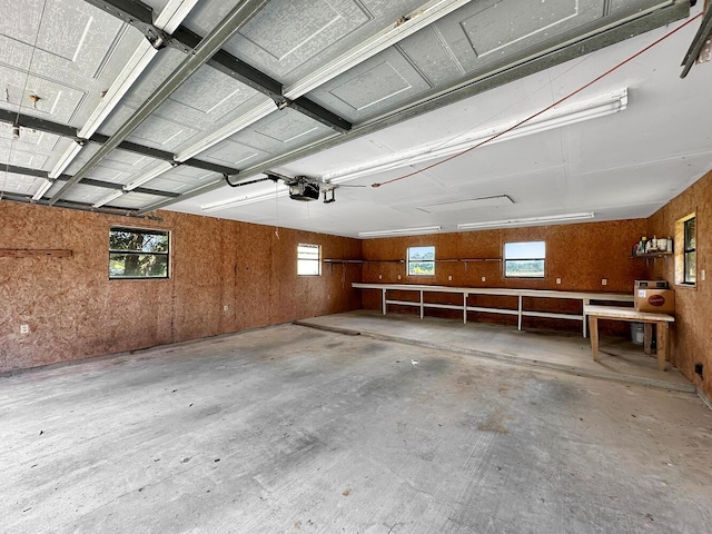 garage with wooden walls and a garage door opener