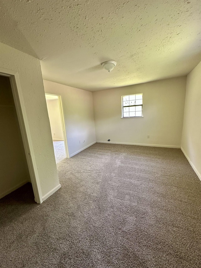 2910 Dowling St, Orange, TX 77630 - unfurnished bedroom featuring a textured ceiling, carpet floors, and baseboards