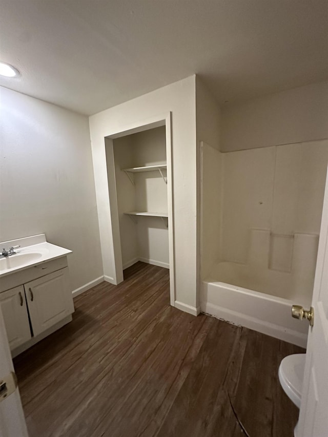 2910 Dowling St, Orange, TX 77630 - full bathroom with vanity, wood finished floors, baseboards, and toilet