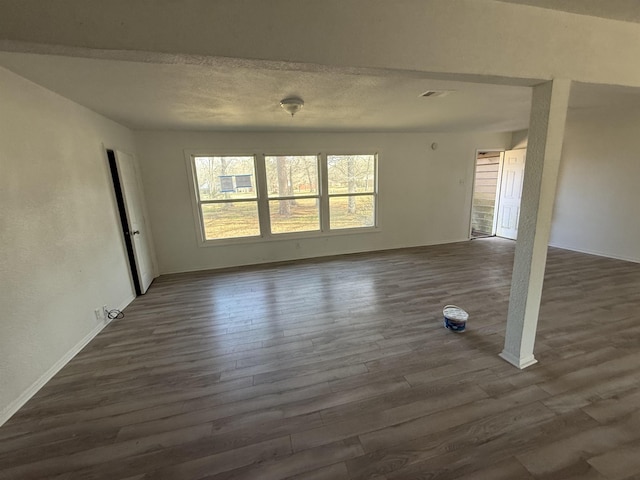 3190 Shivers St, Vidor, TX 77662 - unfurnished living room with dark wood-style flooring and a textured ceiling