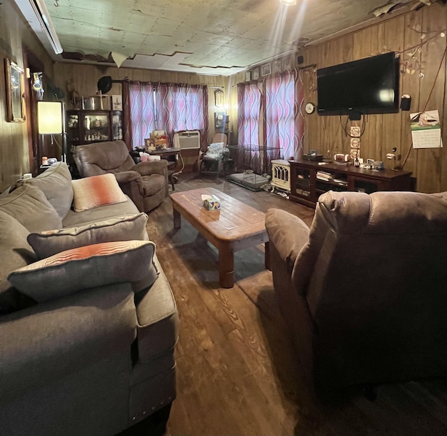 living room featuring hardwood / wood-style flooring and wood walls