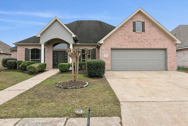 view of front of home featuring a garage and a front lawn