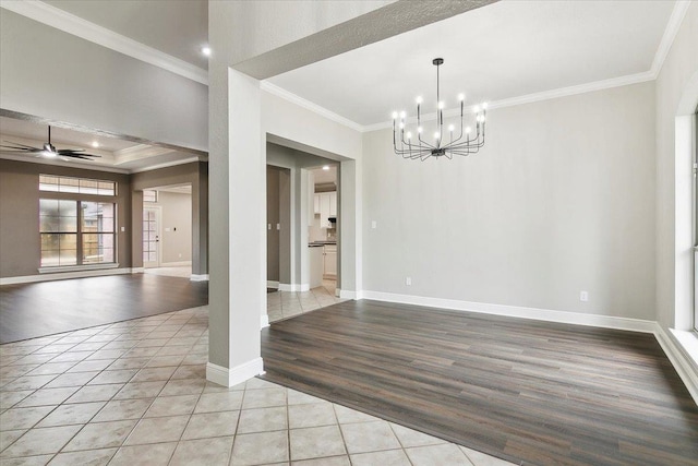 tiled empty room with crown molding and ceiling fan with notable chandelier