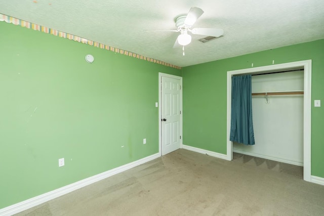 970 Charleston Cir, Bridge City, TX 77611 - unfurnished bedroom with a textured ceiling, a closet, carpet flooring, and ceiling fan
