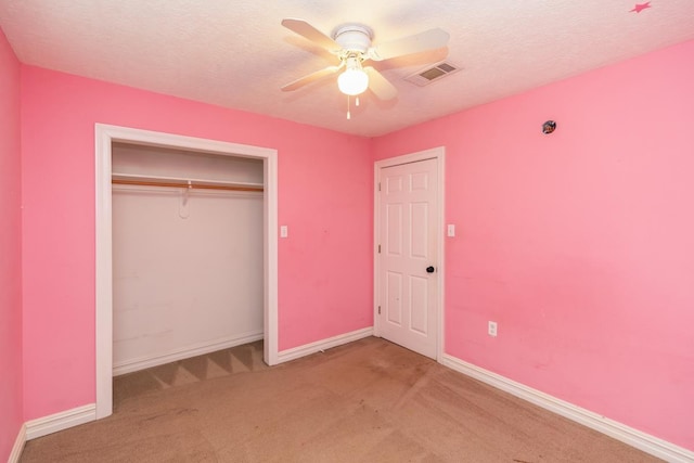 970 Charleston Cir, Bridge City, TX 77611 - unfurnished bedroom with carpet flooring, a closet, a textured ceiling, and ceiling fan
