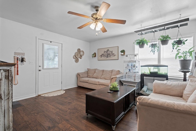1165 Archie St, Vidor, TX 77662 - living area with dark wood-type flooring, a ceiling fan, and baseboards