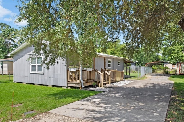 1165 Archie St, Vidor, TX 77662 - manufactured / mobile home with a detached carport, concrete driveway, and a wooden deck