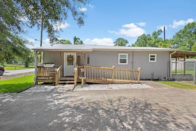 1165 Archie St, Vidor, TX 77662 - view of front of house featuring a wooden deck and metal roof
