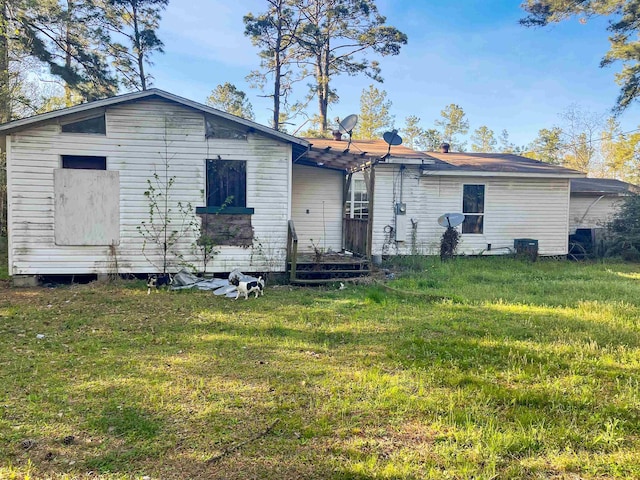 back of house featuring a yard and a deck