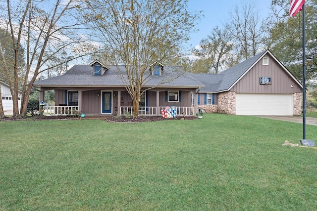 view of front of house with a front yard, a porch, and a garage