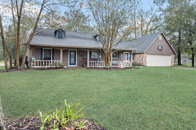 view of front facade featuring a porch, a garage, and a front yard