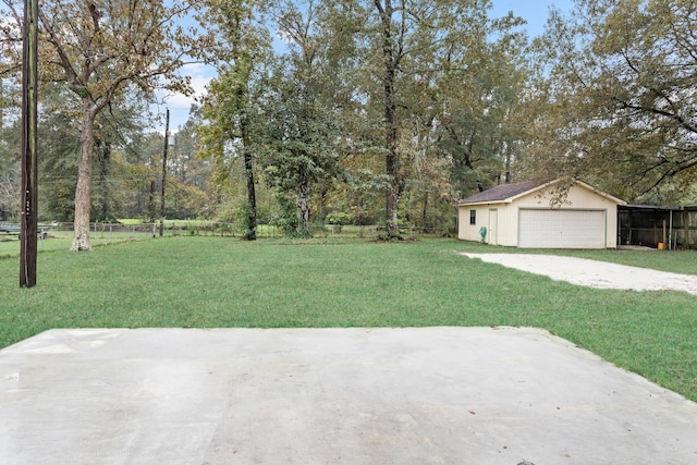 view of yard featuring a garage and an outdoor structure