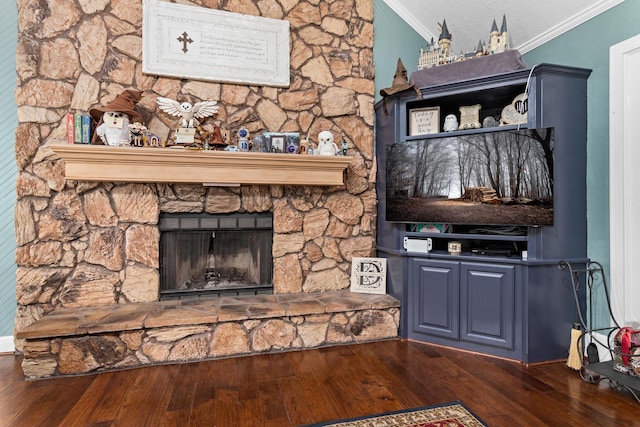 unfurnished living room featuring a stone fireplace, dark wood-type flooring, and ornamental molding