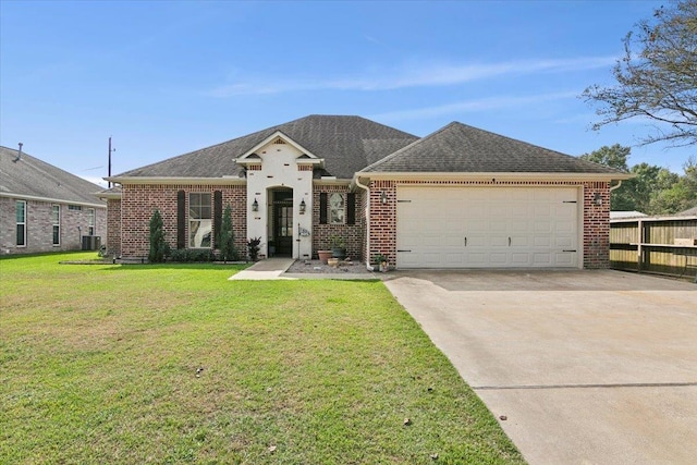 view of front of property with a front yard, a garage, and central air condition unit