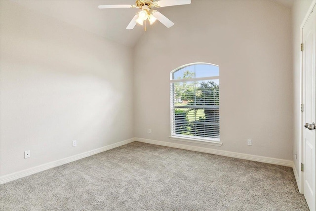 empty room featuring baseboards, a ceiling fan, lofted ceiling, and carpet