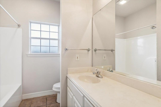 full bathroom with vanity, baseboards, tile patterned flooring, shower / washtub combination, and toilet