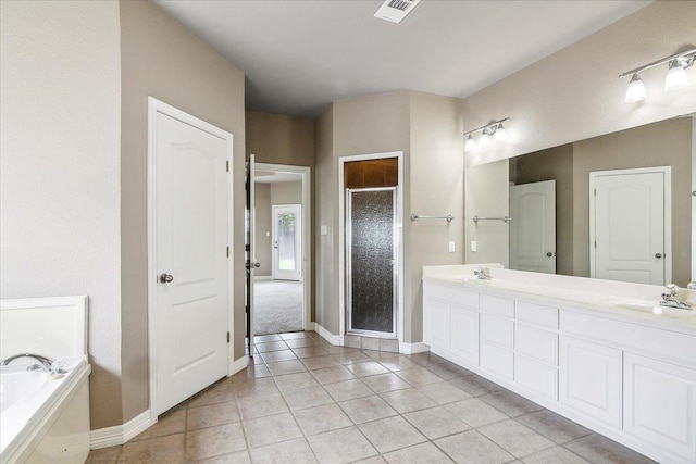 full bathroom featuring visible vents, double vanity, a stall shower, a sink, and tile patterned floors