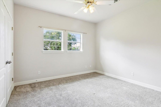 empty room featuring baseboards, carpet floors, and a ceiling fan