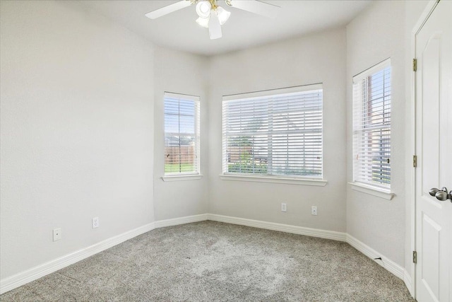 unfurnished room with baseboards, ceiling fan, and carpet floors