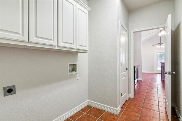 washroom with dark tile patterned flooring, washer hookup, cabinet space, baseboards, and hookup for an electric dryer