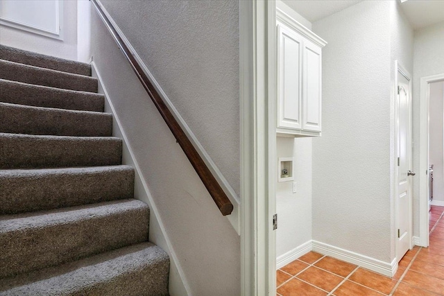 stairs with tile patterned flooring and baseboards