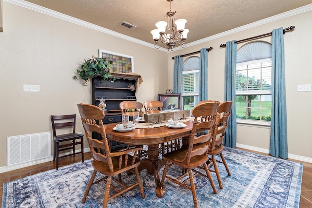 dining room with visible vents, baseboards, crown molding, and a chandelier