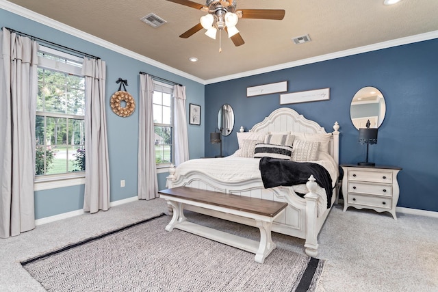 bedroom featuring baseboards, ornamental molding, carpet flooring, and visible vents