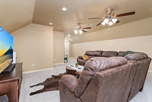 living room featuring visible vents, a textured ceiling, lofted ceiling, and light carpet