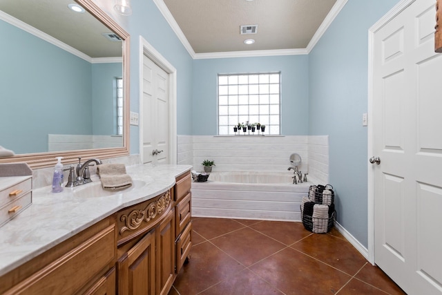 bathroom with crown molding, a bath, and visible vents