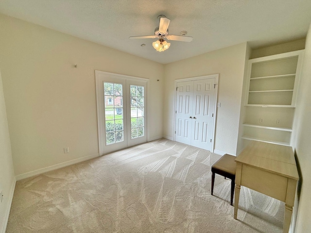 unfurnished bedroom featuring carpet flooring, baseboards, and a ceiling fan