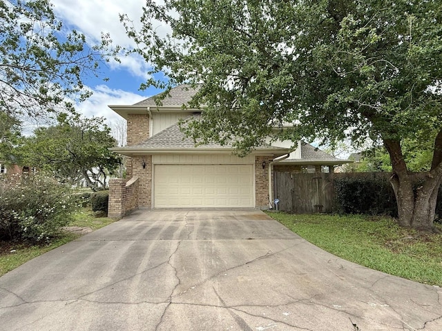 view of front of house with a garage, roof with shingles, fence, brick siding, and driveway
