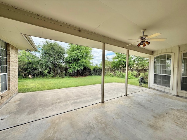 view of patio / terrace with ceiling fan and fence
