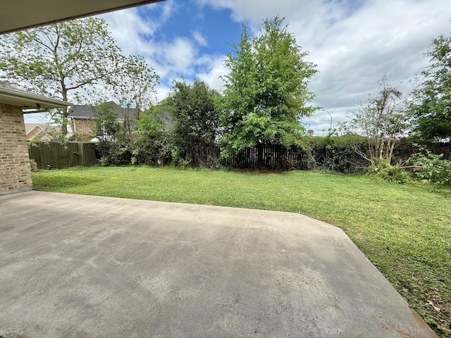 view of yard featuring a patio and fence