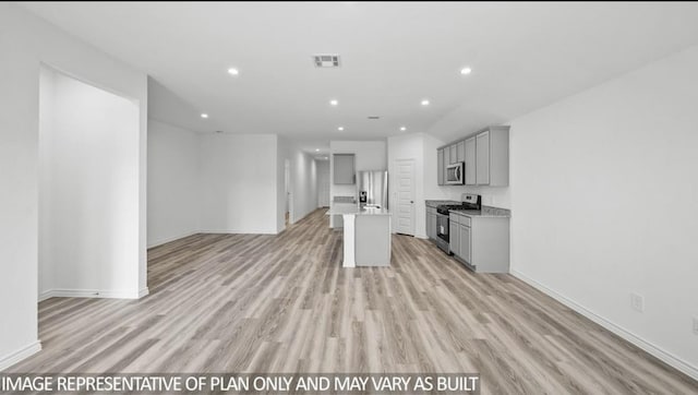 1670 Haidlyns Way, Sour Lake, TX 77659 - kitchen featuring gray cabinetry, stainless steel appliances, open floor plan, light wood-type flooring, and light countertops