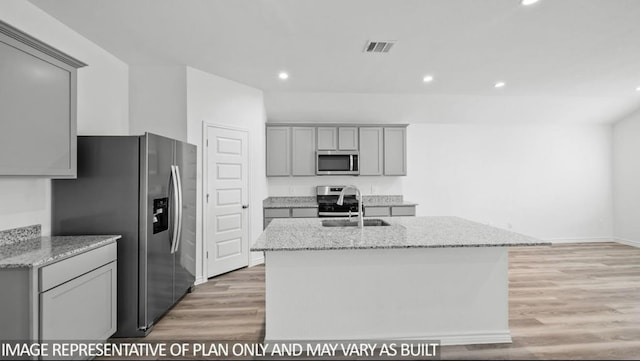 1670 Haidlyns Way, Sour Lake, TX 77659 - kitchen with stainless steel appliances, gray cabinetry, a sink, light wood-style floors, and recessed lighting