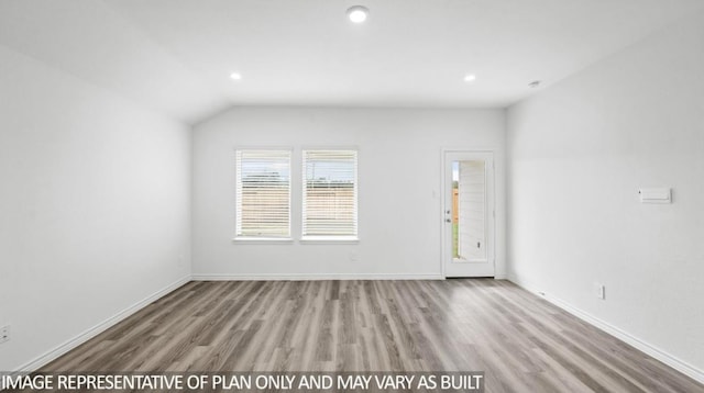 1670 Haidlyns Way, Sour Lake, TX 77659 - unfurnished living room with wood finished floors, recessed lighting, baseboards, and vaulted ceiling