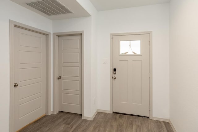 entrance foyer featuring visible vents, light wood-style flooring, and baseboards