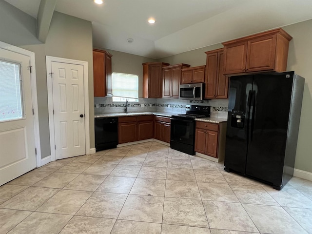 kitchen with light tile patterned floors, sink, black appliances, and decorative backsplash