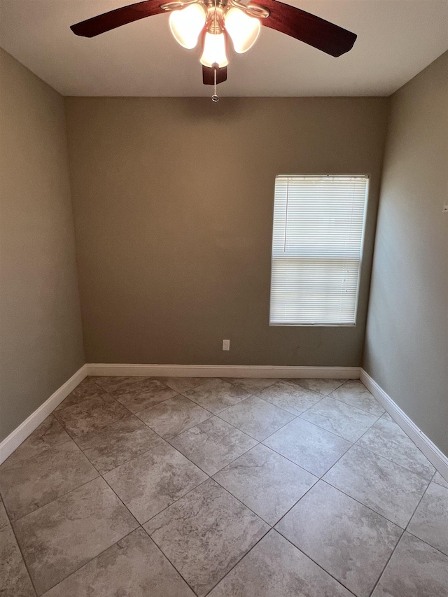 unfurnished room with light tile patterned flooring and ceiling fan