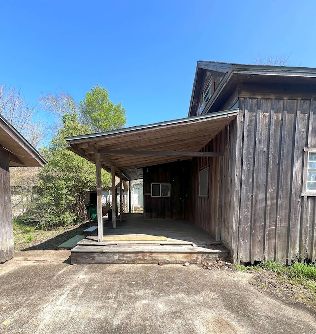 view of vehicle parking featuring driveway and a shed