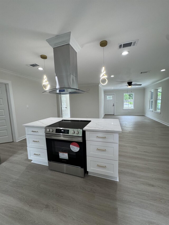 3824 Hays Ave, Groves, TX 77619 - kitchen with stainless steel range with electric stovetop, island range hood, open floor plan, white cabinets, and ceiling fan