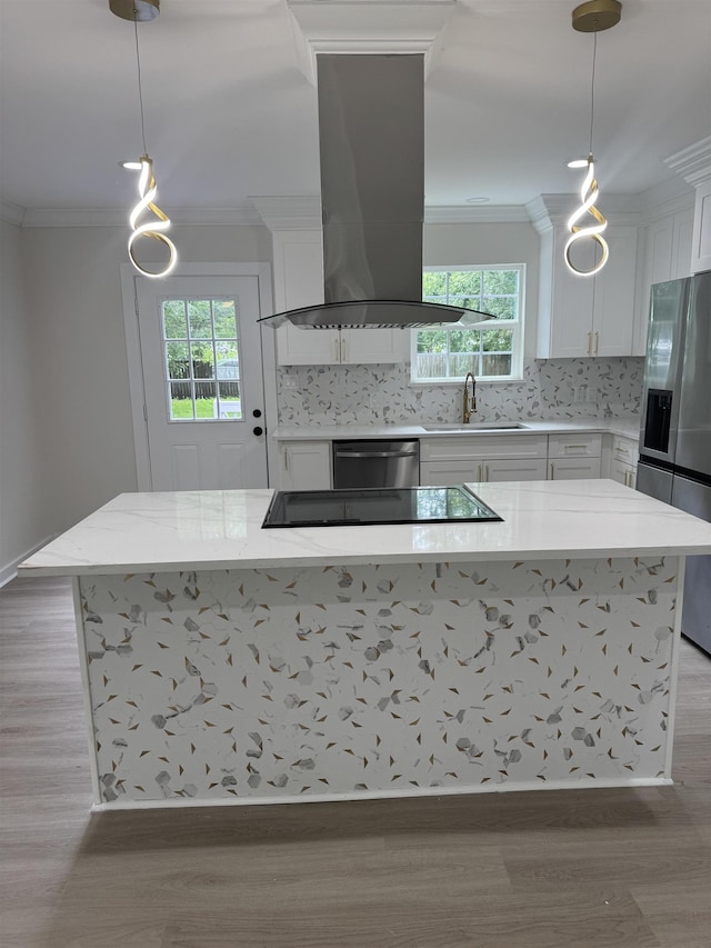 3824 Hays Ave, Groves, TX 77619 - kitchen with stainless steel appliances, island range hood, ornamental molding, light wood finished floors, and decorative backsplash