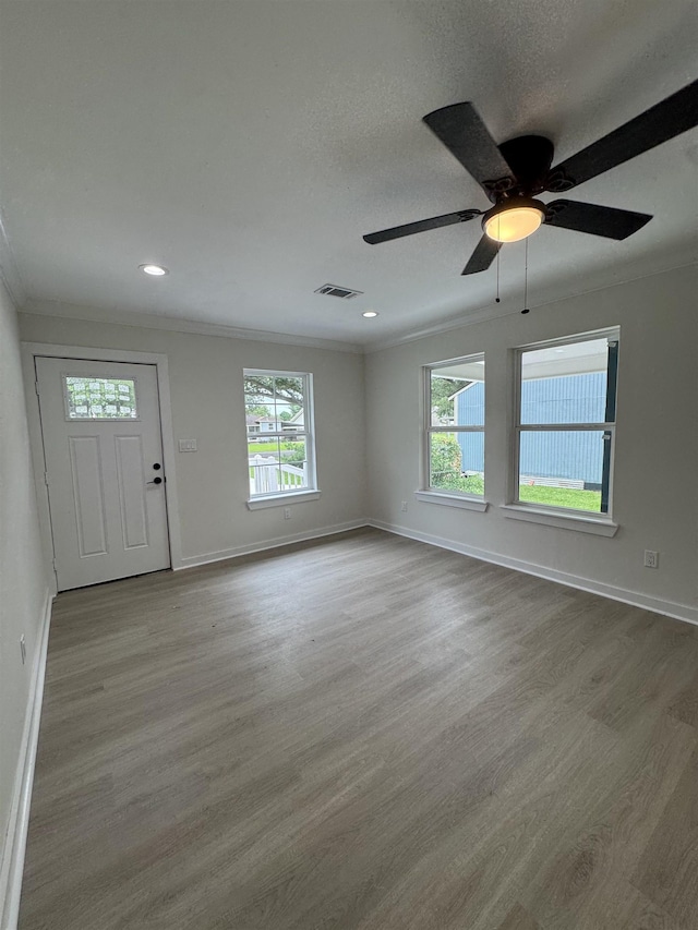 3824 Hays Ave, Groves, TX 77619 - entryway featuring ornamental molding, healthy amount of natural light, wood finished floors, recessed lighting, and ceiling fan